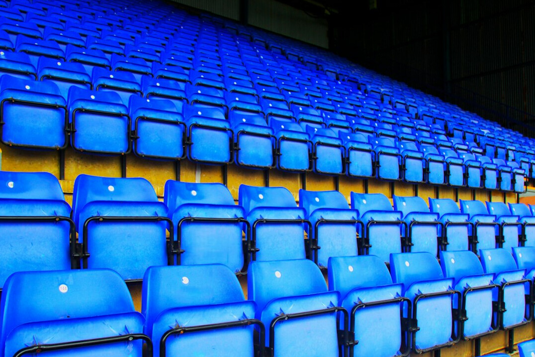 Empty stadium seating bathed in evening light