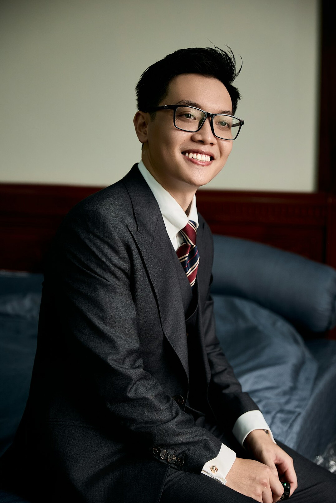 Studio portrait of a man with glasses in a suit