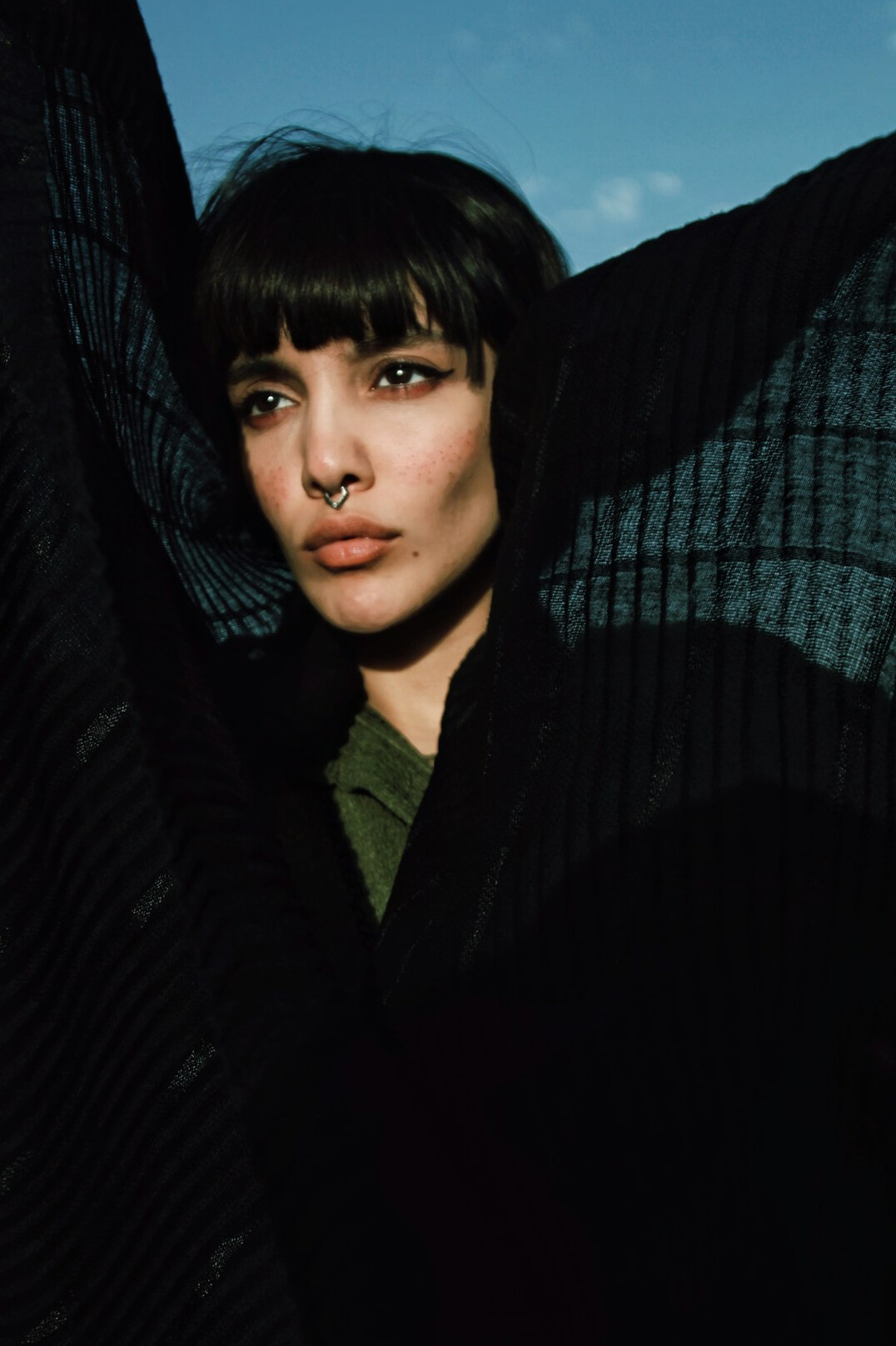 Studio portrait of a woman editor with short dark hair
