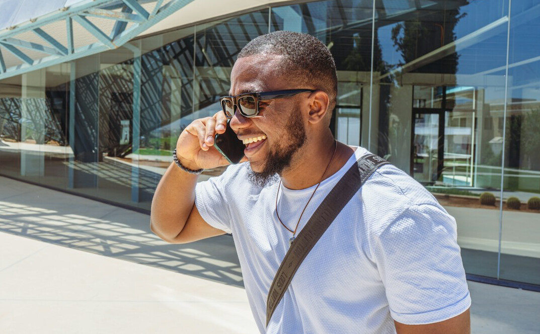 Journalist answering a phone call at a busy news desk